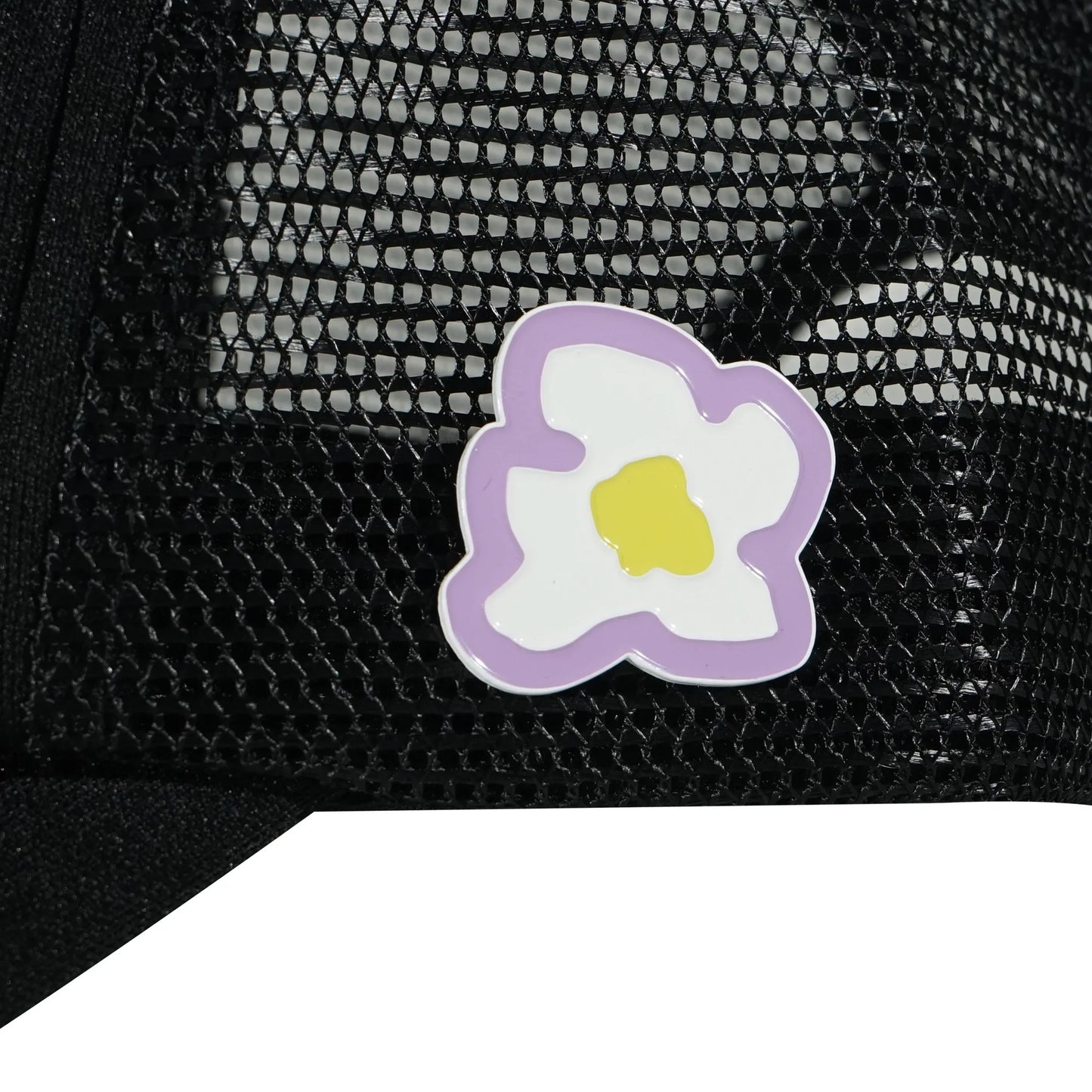 Left side flower pins detail on black trucker cap