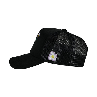 Black trucker cap left side view with pins flower