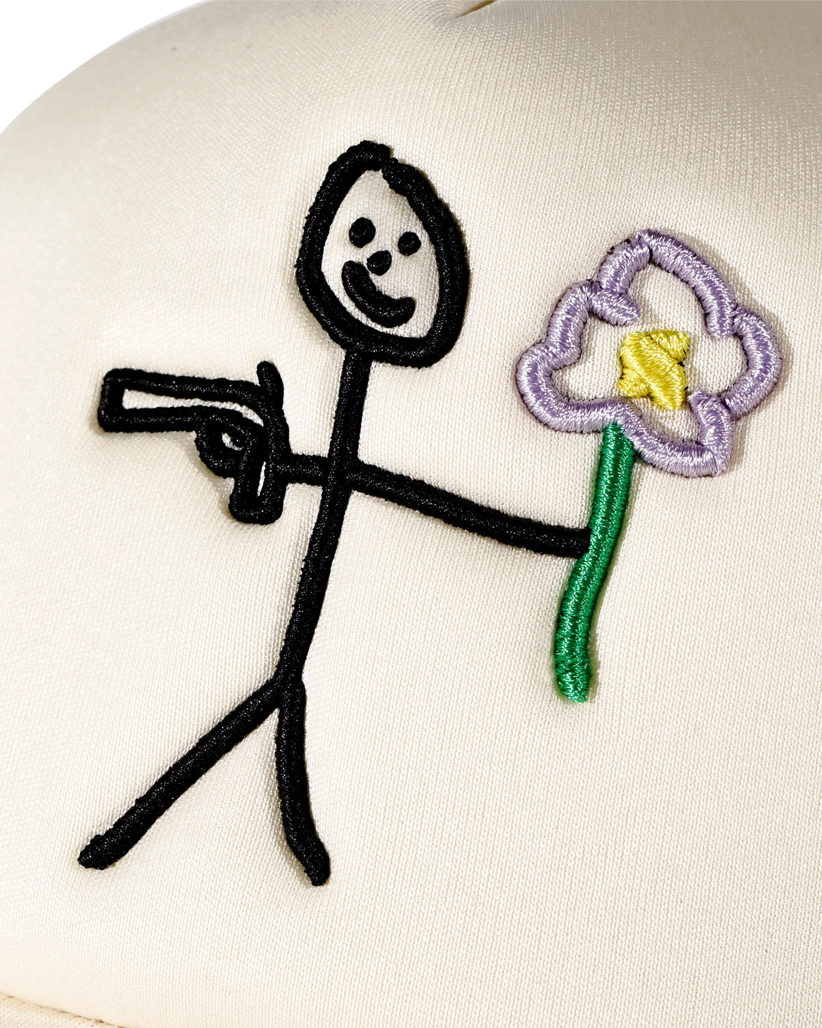 Embroidered stickman gun and flower logo front detail on cream trucker cap - tell them why not