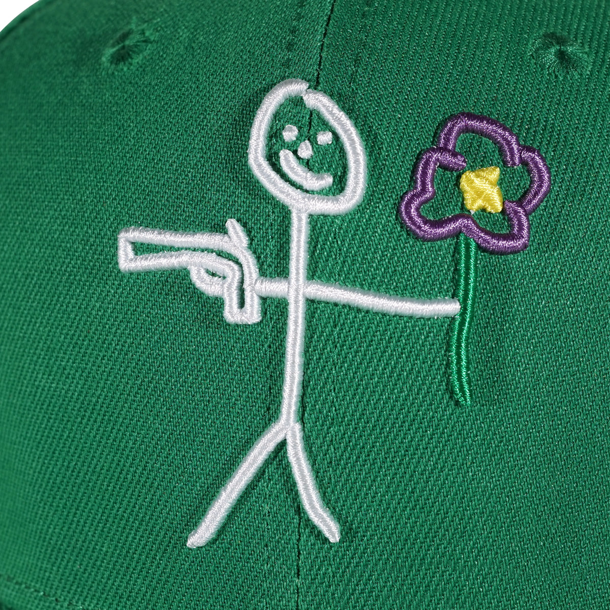 Embroidered stickman logo detail on green snapback cap - tell them why not