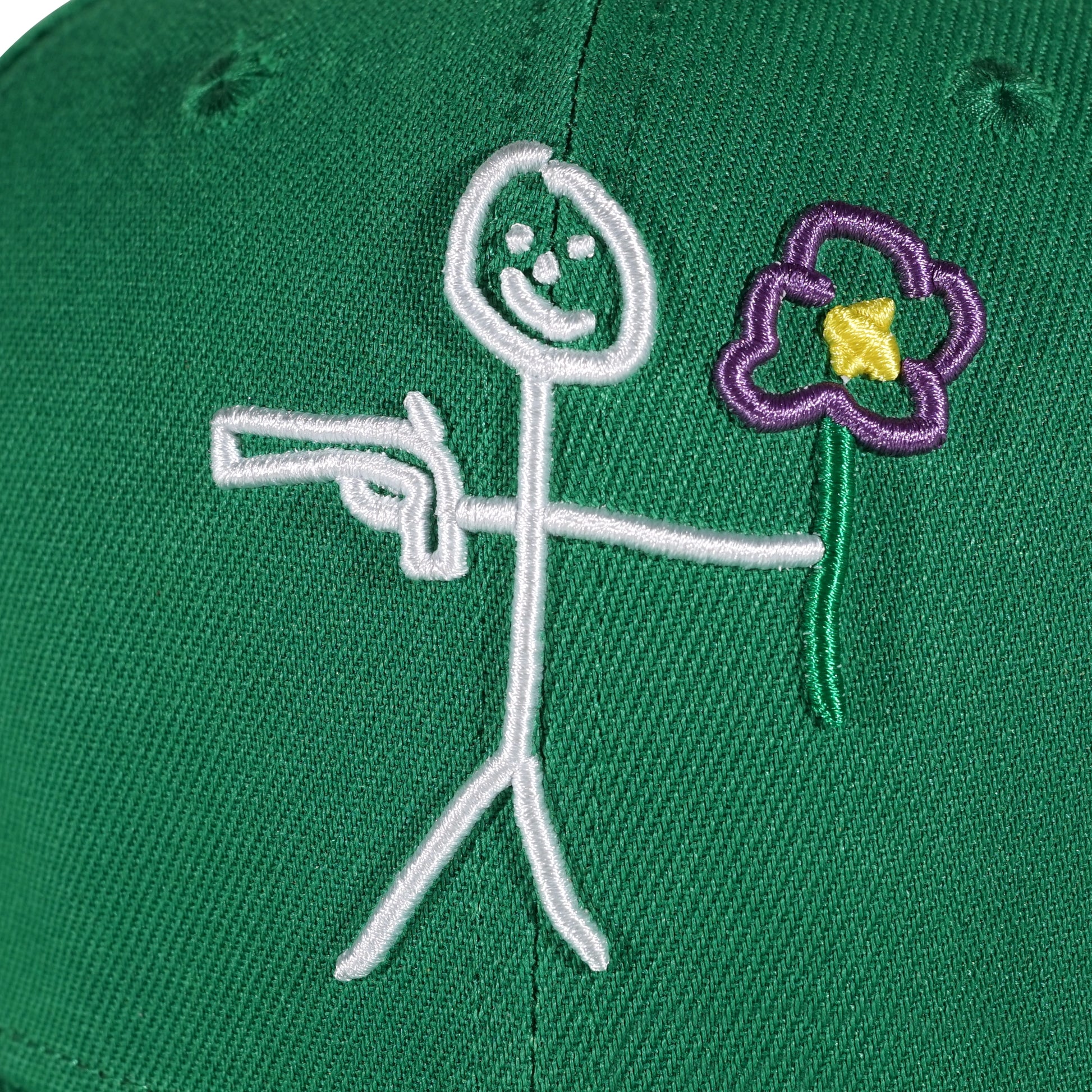 Embroidered stickman logo detail on green snapback cap - tell them why not