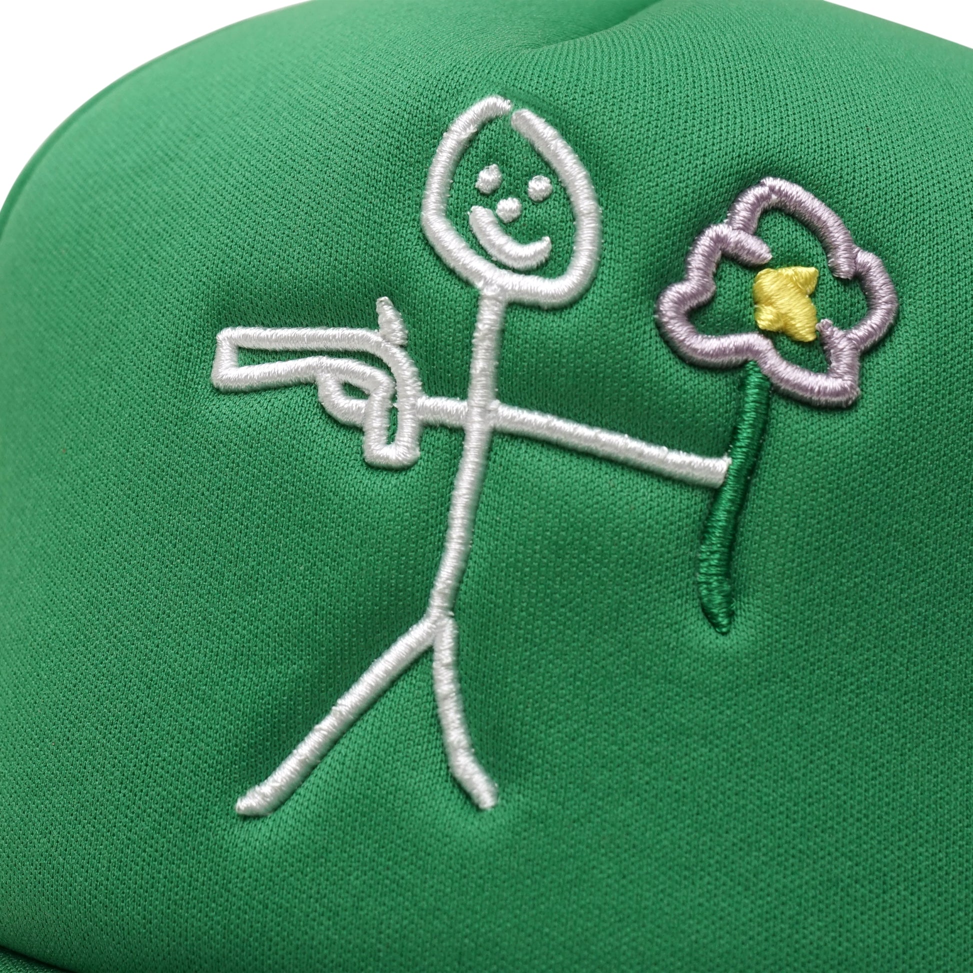Embroidered stickman gun and flower logo front detail on green trucker cap
