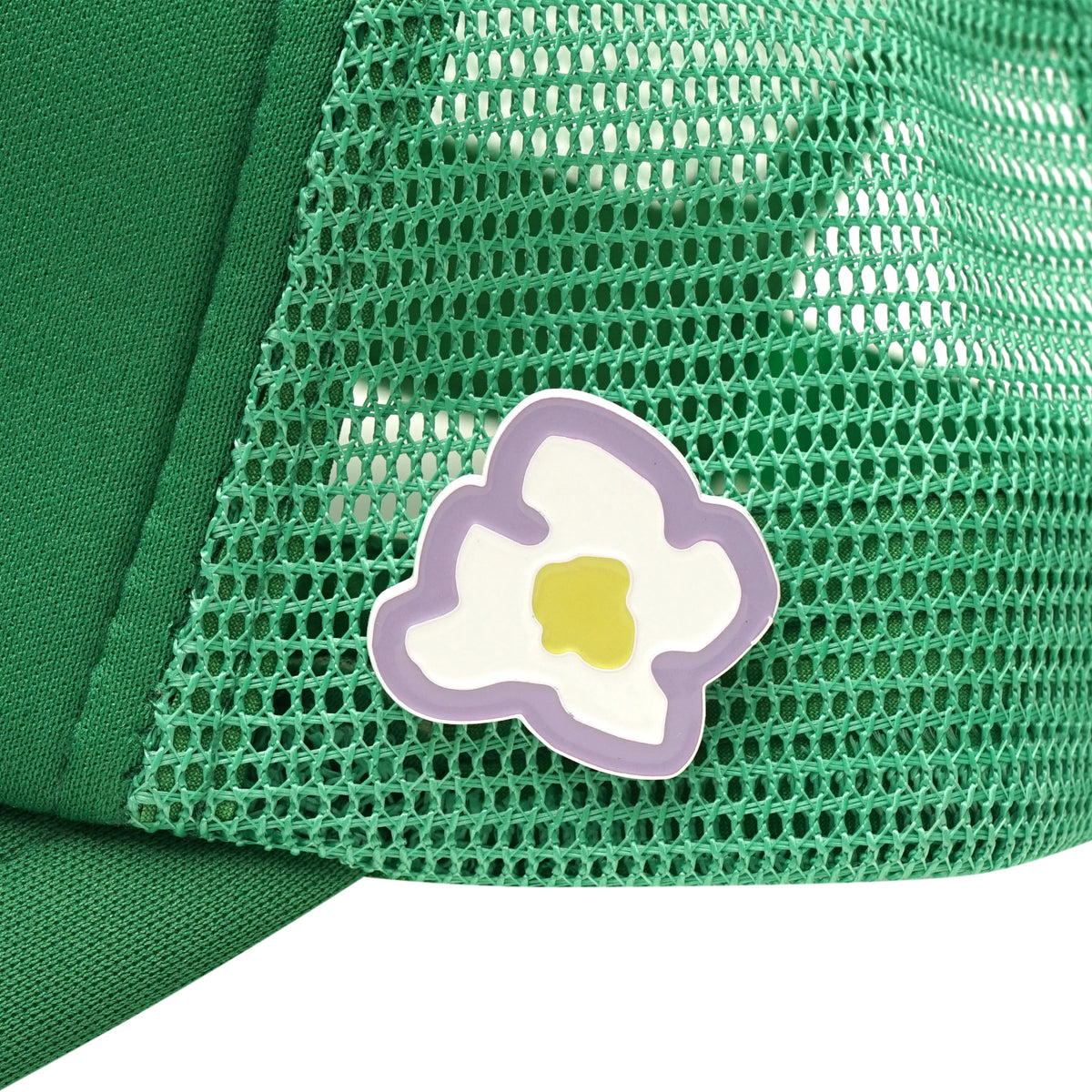 Left side flower pins detail on green trucker cap