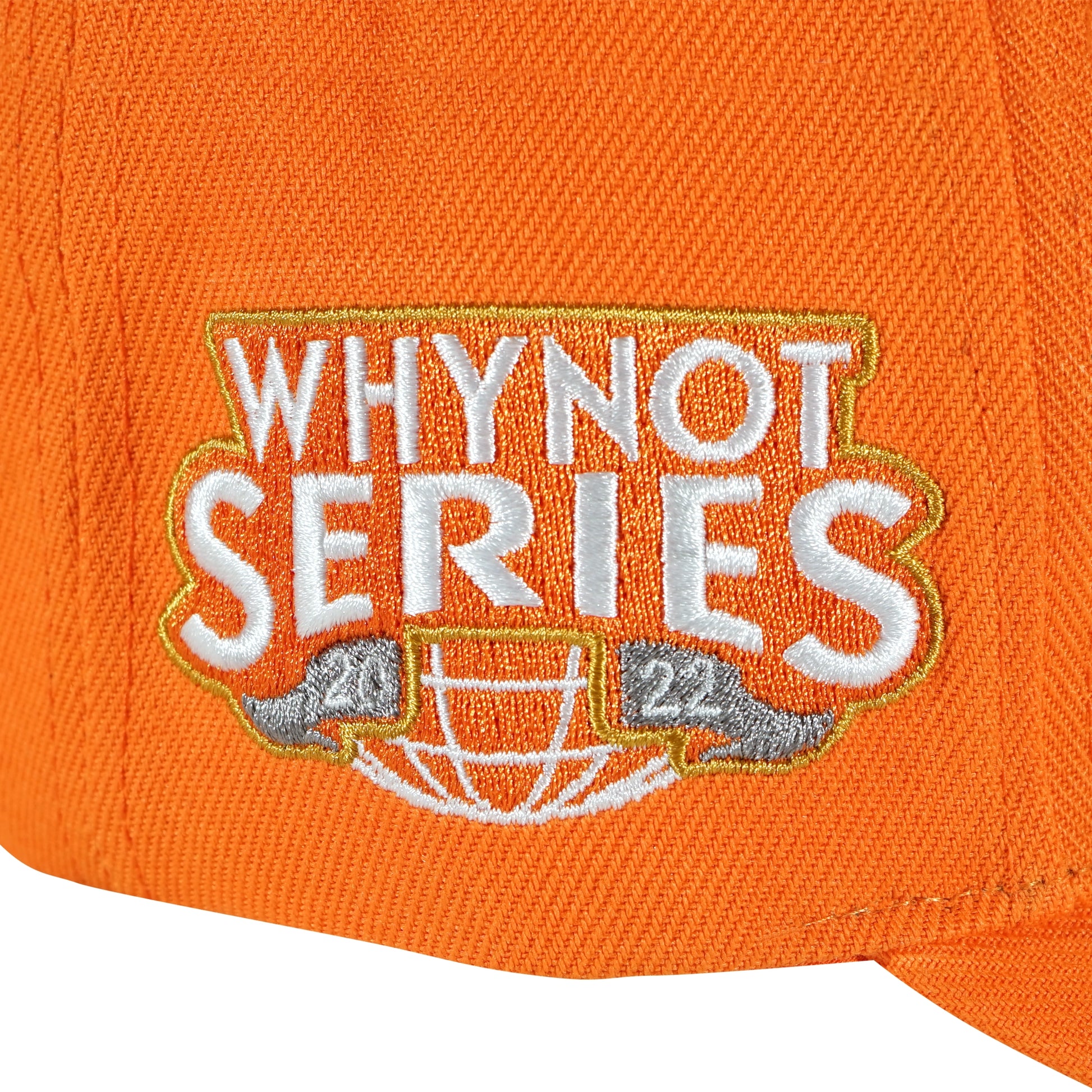 Whynot Series embroidery side detail on orange snapback cap - tell them why not